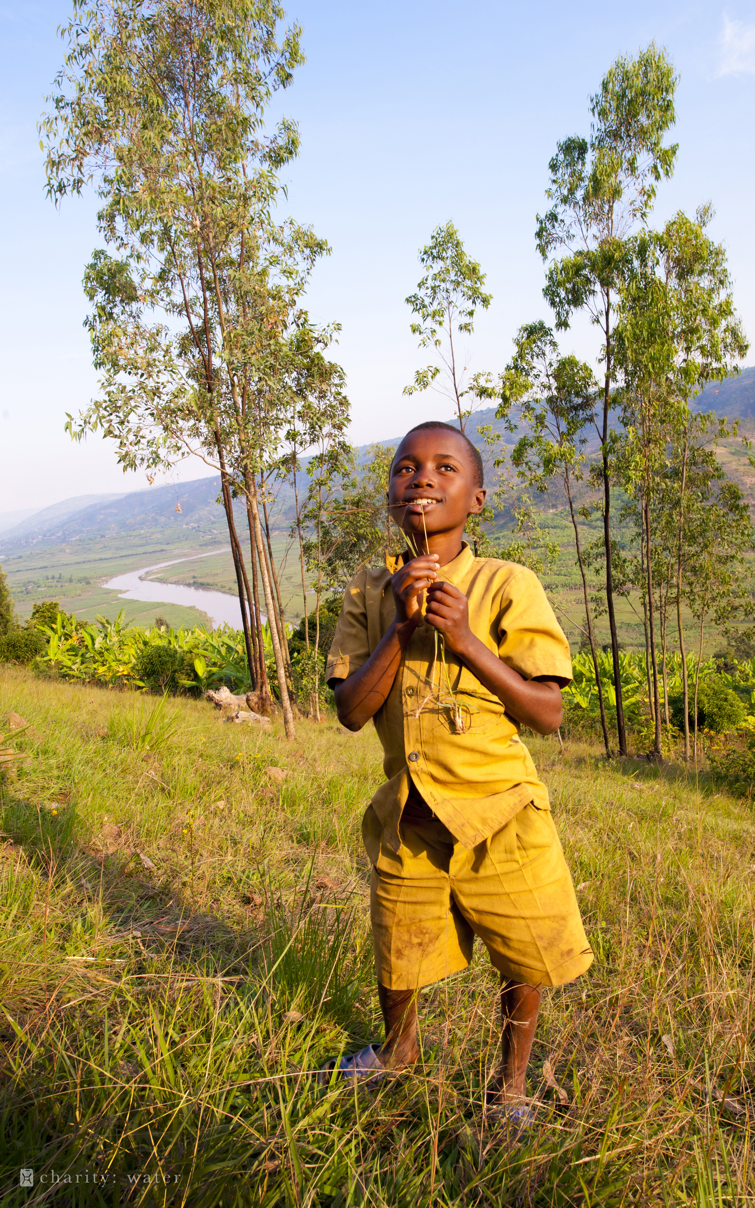 charity: water september campaign boy on Rwanda hillside